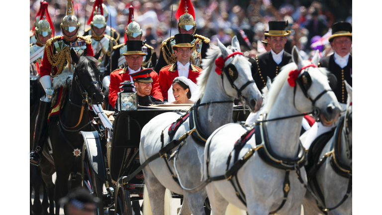 Prince Harry, Duke of Sussex and the Duchess of Sussex ride a horse-drawn carriage