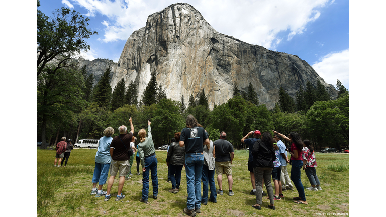 Visitors look up at the El Capitan monolith in the Yosemite National Park in California on June 4, 2015. It is one of America's most popular natural wonders. But even Yosemite National Park cannot escape the drought ravaging California, now in its fourth year and fueling growing concern. At first glance the spectacular beauty of the park with its soaring cliffs and picture-postcard valley floor remains unblemished, still enchanting the millions of tourists who flock the landmark every year. But on closer inspection, the drought's effects are clearly visible. AFP PHOTO/MARK RALSTON