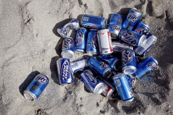 Beer Cans in the Sand - Getty Images