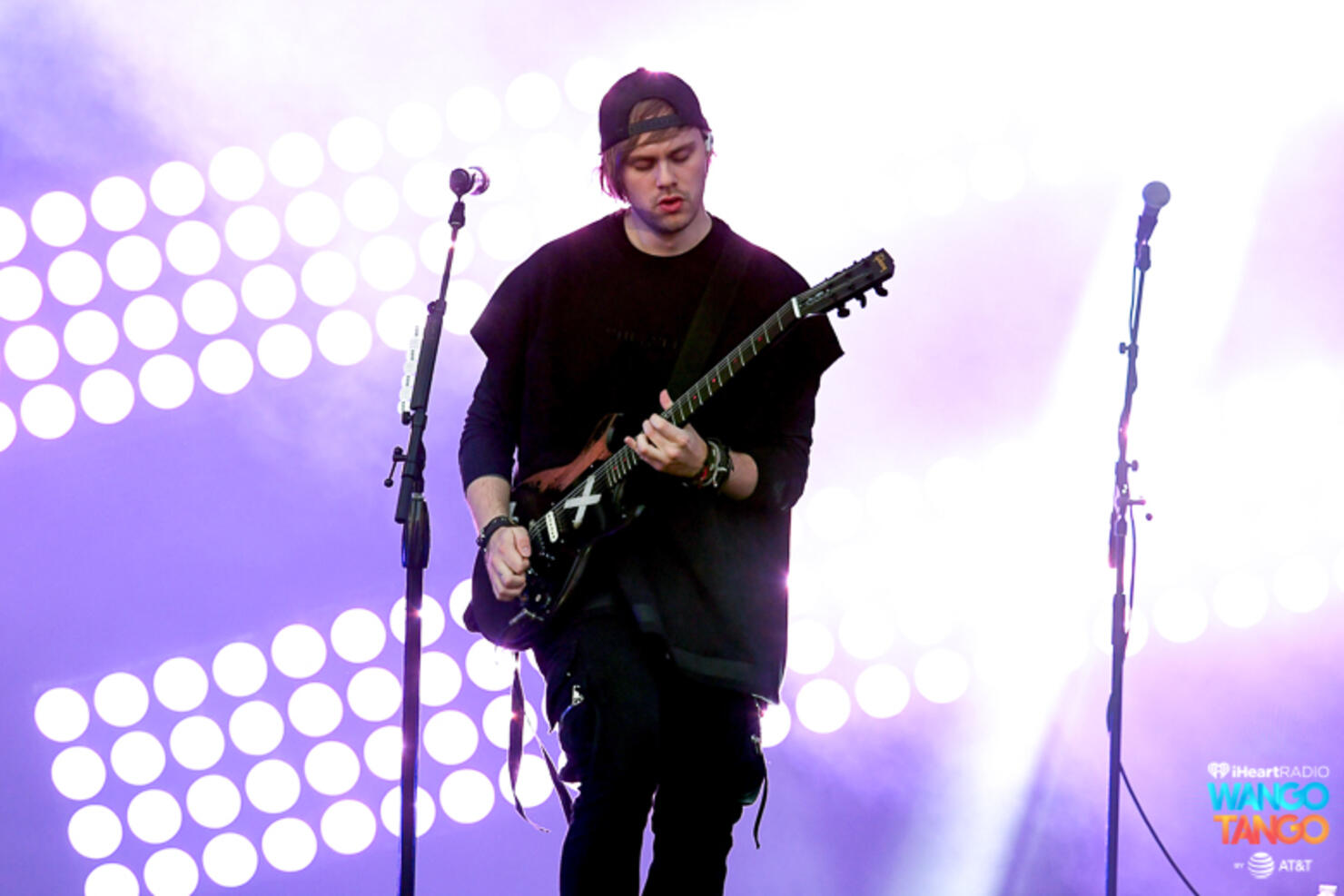 Michael Clifford, Luke Hemmings, Ashton Irwin (on drum riser), and Calum Hood of music group 5 Seconds of Summer perform onstage during the 2018 iHeartRadio Wango Tango by AT&T at Banc of California Stadium on June 2, 2018 in Los Angeles, California.