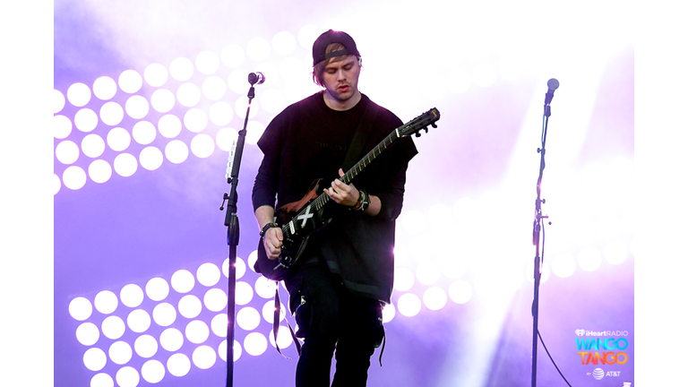 Michael Clifford, Luke Hemmings, Ashton Irwin (on drum riser), and Calum Hood of music group 5 Seconds of Summer perform onstage during the 2018 iHeartRadio Wango Tango by AT&T at Banc of California Stadium on June 2, 2018 in Los Angeles, California.