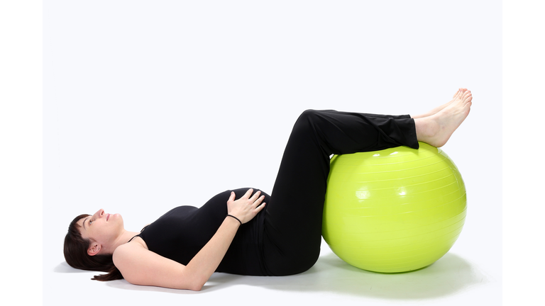 Pregnant woman with a fitness ball (Credit: iStock / Getty Images Plus)