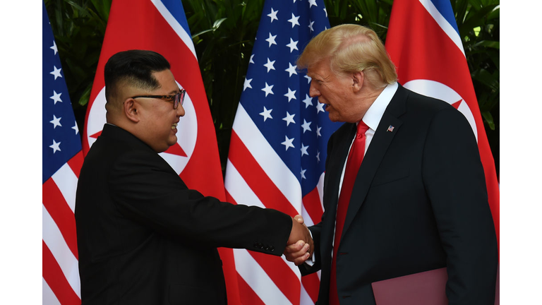 North Korea's leader Kim Jong Un (L) shakes hands with US President Donald Trump (R) after taking part in a signing ceremony at the end of their historic US-North Korea summit, at the Capella Hotel on Sentosa island in Singapore on June 12, 2018. - Donald Trump and Kim Jong Un became on June 12 the first sitting US and North Korean leaders to meet, shake hands and negotiate to end a decades-old nuclear stand-off. (Photo ANTHONY WALLACE/AFP/Getty Images