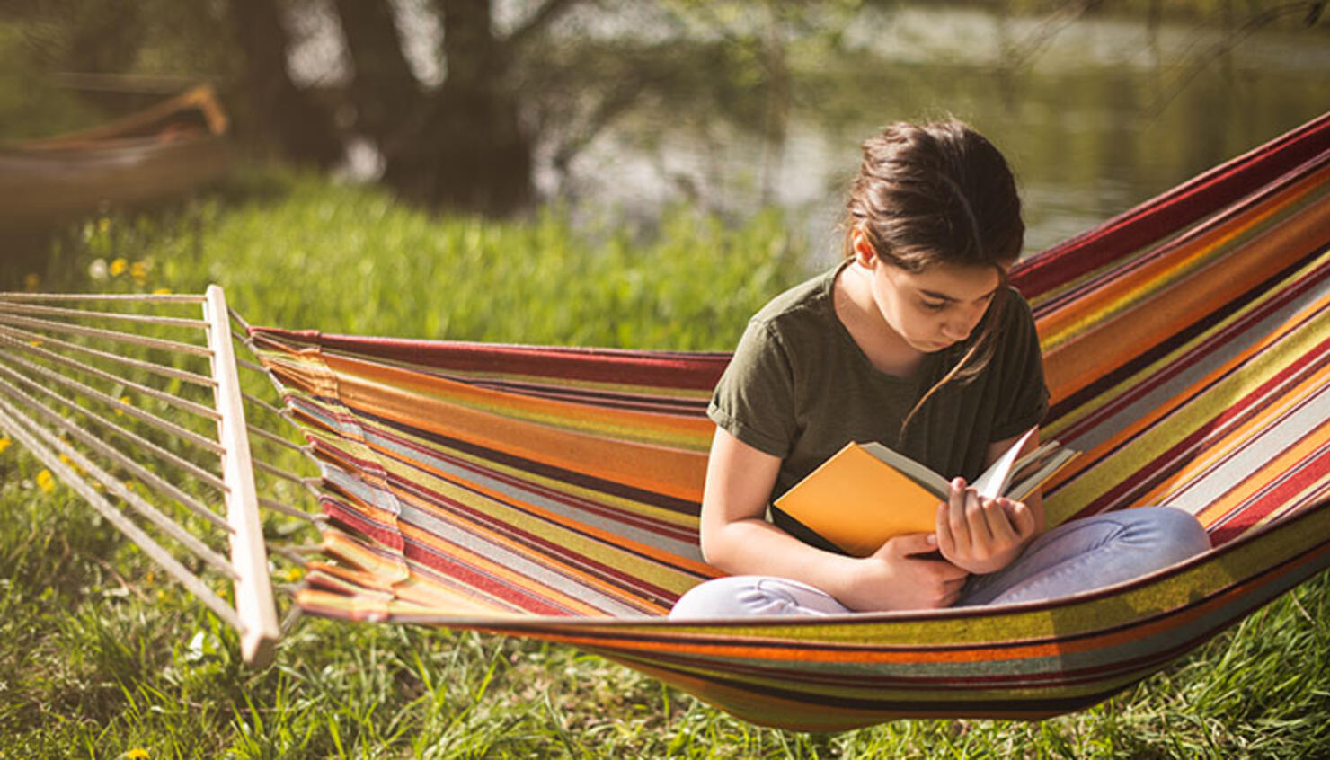 girl reading in hammock