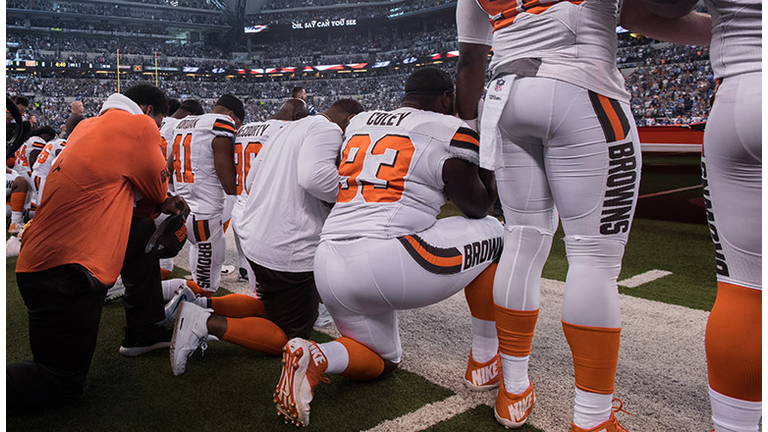 Cleveland Browns players take a knee during the national anthem