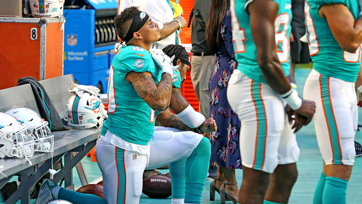 Miami Dolphins receivers Kenny Stills and Albert Wilson kneel during the national anthem