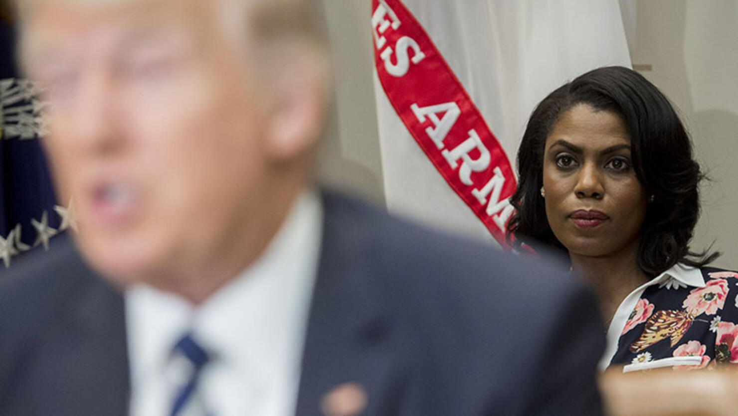 Omarosa Manigault (R), White House Director of Communications for the Office of Public Liaison, sits behind US President Donald Trump