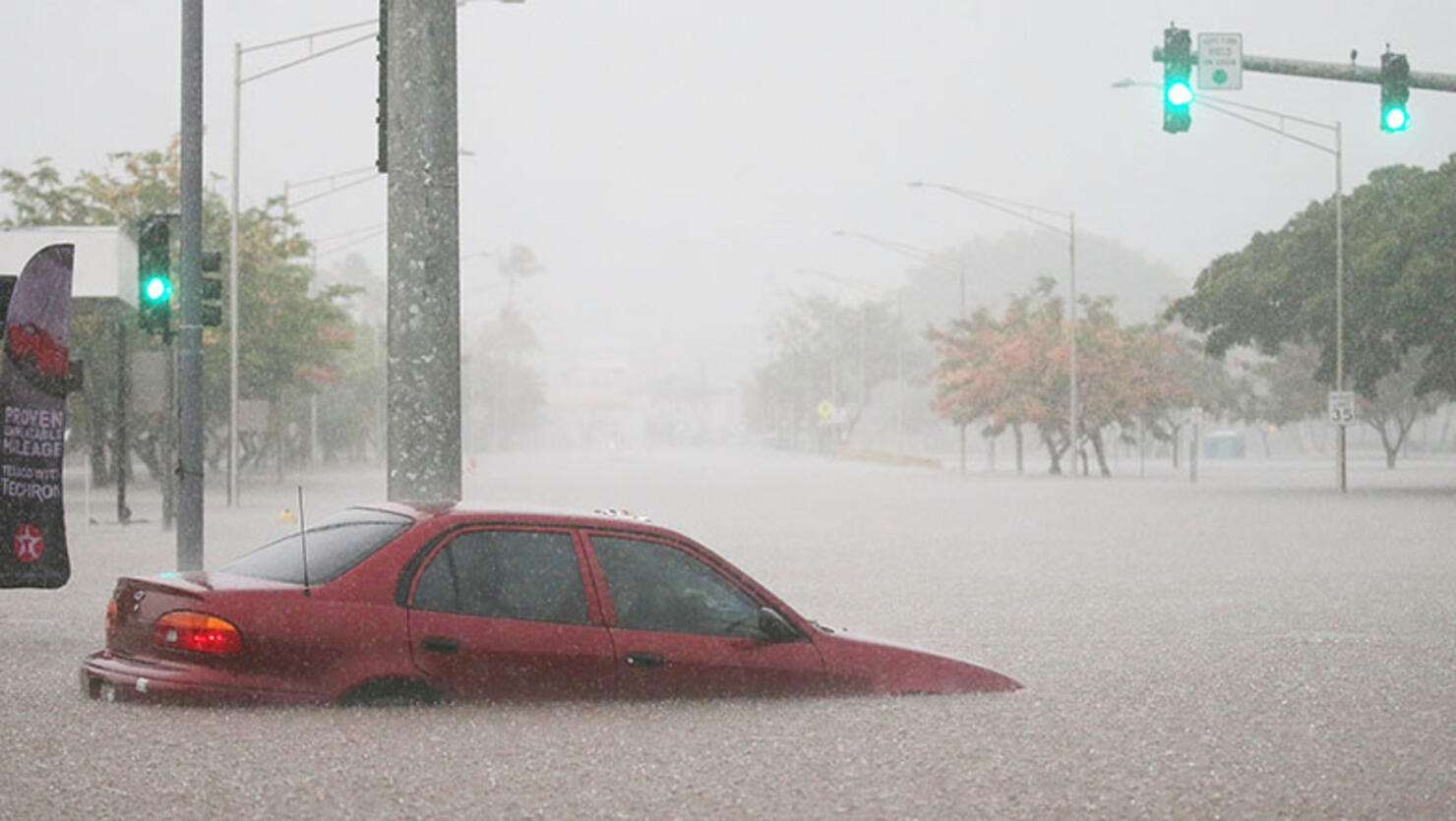 A car is stuck partially submerged in floodwaters from Hurricane Lane rainfall on the Big Island on August 23, 2018 in Hilo, Hawaii.
