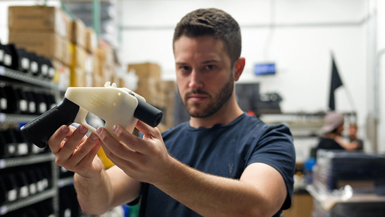 Cody Wilson, owner of Defense Distributed company, holds a 3D printed gun, called the 'Liberator', in his factory in Austin, Texas