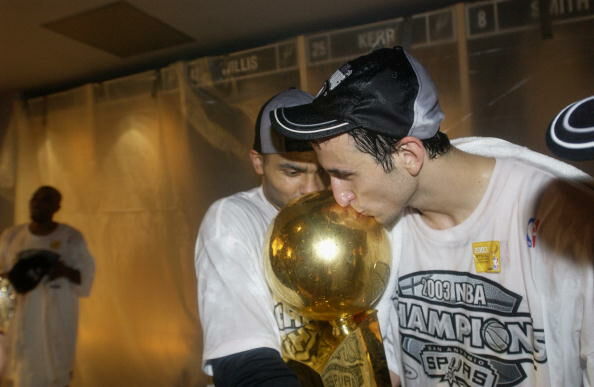 Manu Ginobili  and Tony Parker kiss the Championship trophy in 2003.