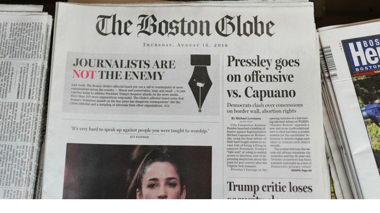 CAMBRIDGE, MA - AUGUST 16: The front page of the Thursday, August 16, 2018 edition of the Boston Globe newspaper reads 'Journalists are Not the Enemy' as it sits for sale at Out of Town News on August 16, 2018 in Cambridge, Massachusetts. Hundreds of U.S. newspapers joined together and published editorials decrying President Donald Trump's description of the media as the 'enemy of the people.' (Photo by Tim Bradbury/Getty Images)