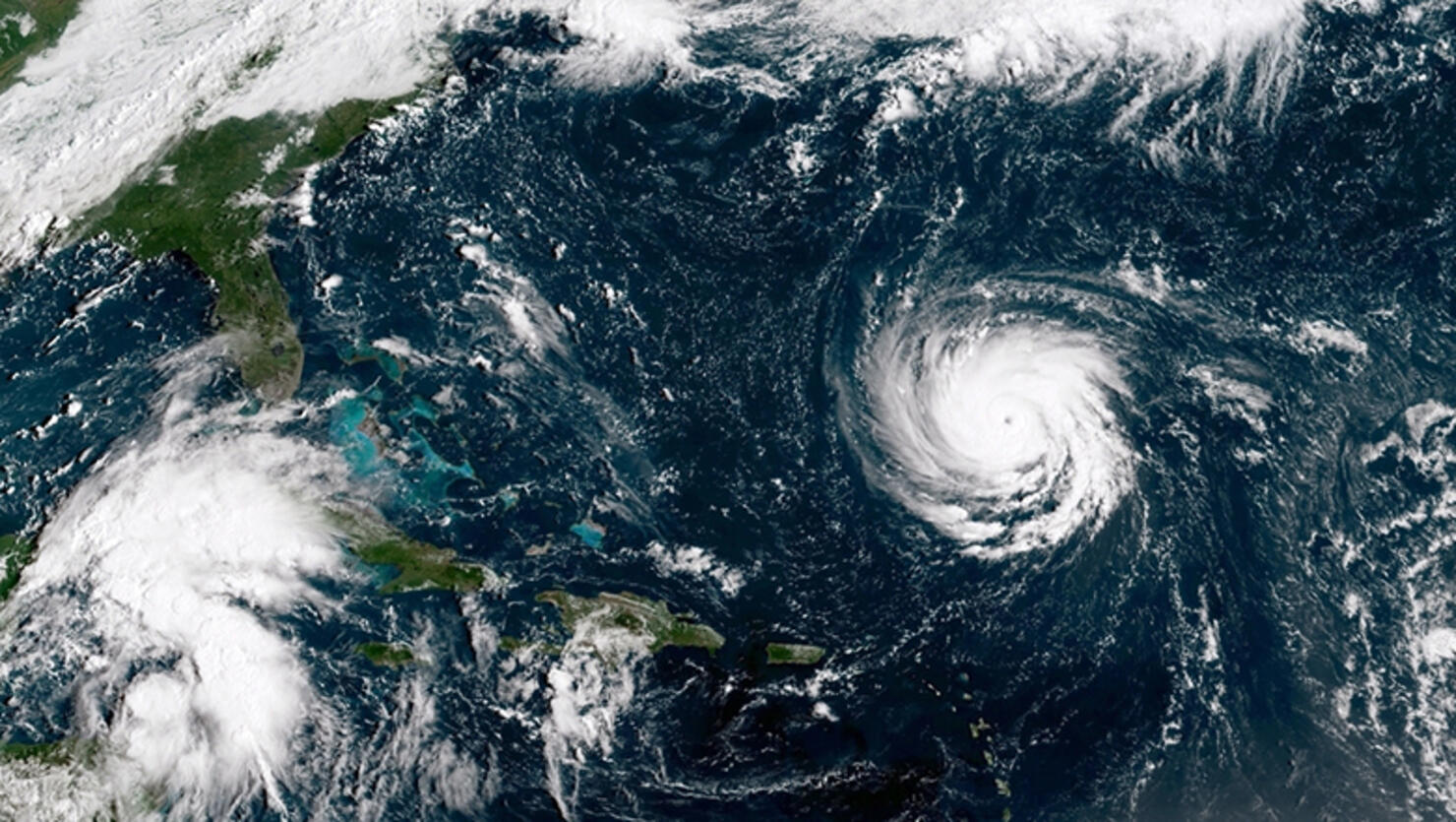In this NOAA satellite handout image, shows Hurricane Florence (C) as it gains strength in the Atlantic Ocean southeast of Bermuda moving west on September 10, 2018. Hurricane Isaac and Helene can be seen to the east of Florence