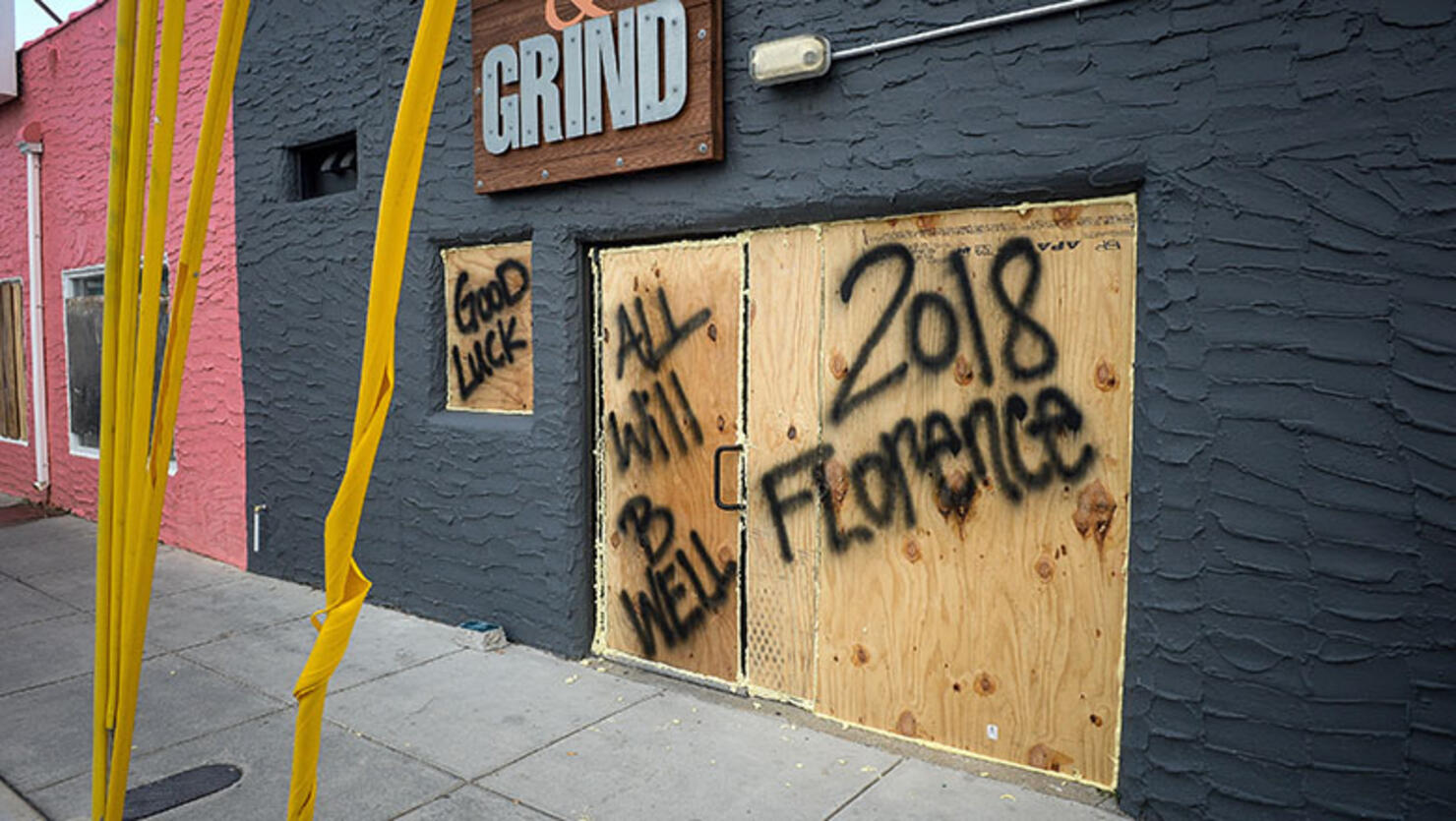 Plywood displaying messages protects window and doors of a property ahead of Hurricane Florence in Carolina Beach, North Carolina