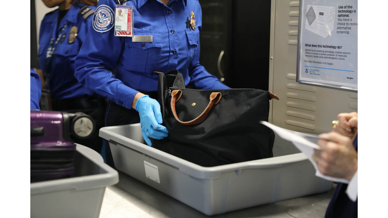 NEW YORK, NY - SEPTEMBER 26: A Transportation Security Administration (TSA) worker screens luggage at LaGuardia Airport (LGA) on September 26, 2017 in New York City. Passengers traveling on Delta at Terminal C will now go through new automated security screening lanes that hat officials claim will improve security while reducing wait times by 30 percent. The new automated security lanes, which have recently launched at some terminals at neighboring John F. Kennedy Airport, feature four partitioned areas for passengers to load their belongings, as well as a second rotating belt for bins. These bins, which are 25 percent larger, are automatically sent back to the front of the line after each use, freeing up TSA officers to focus on the screening travelers. (Photo by Spencer Platt/Getty Images)