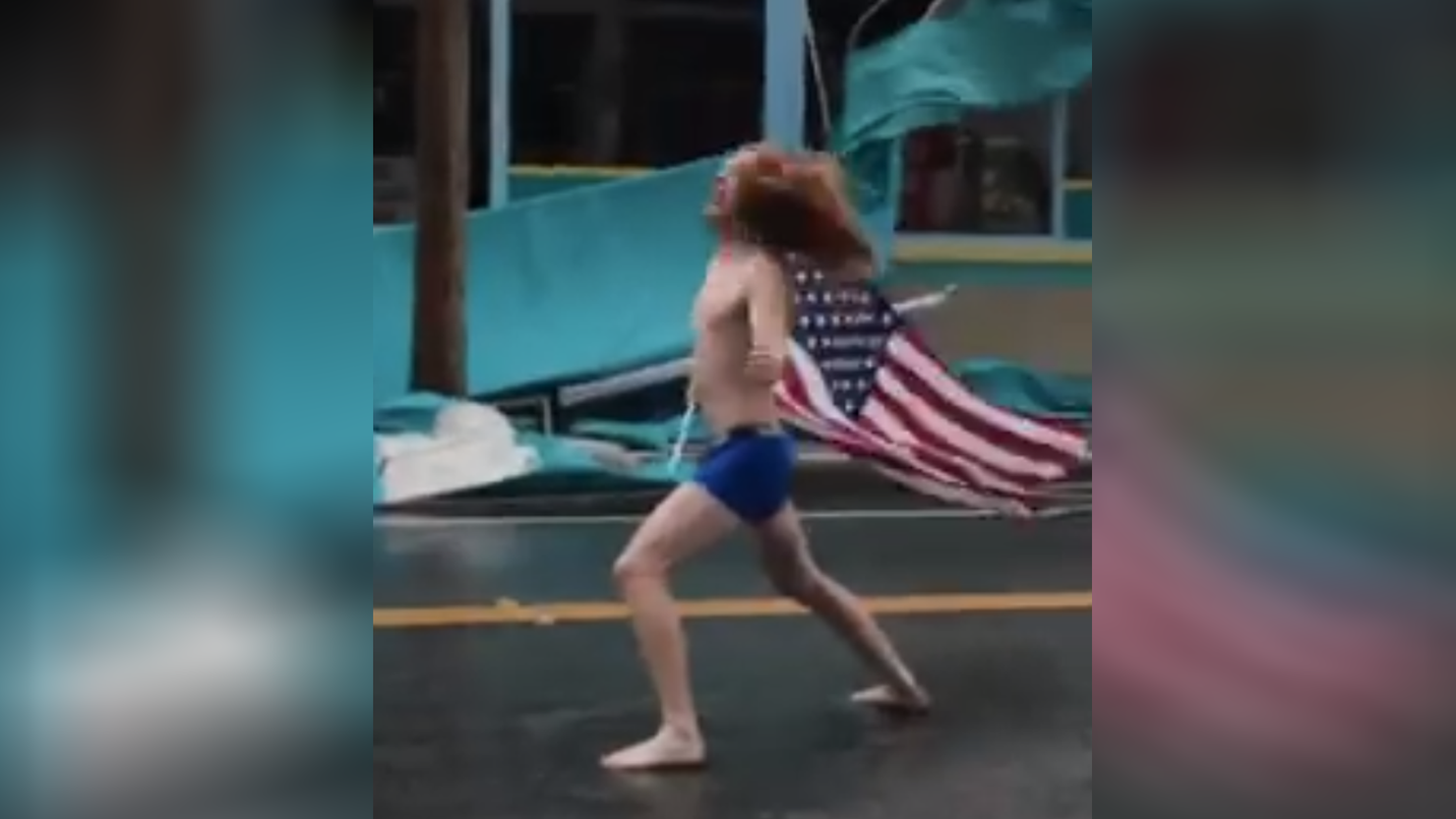 Shirtless man with American Flag Stares down Hurricane Florence