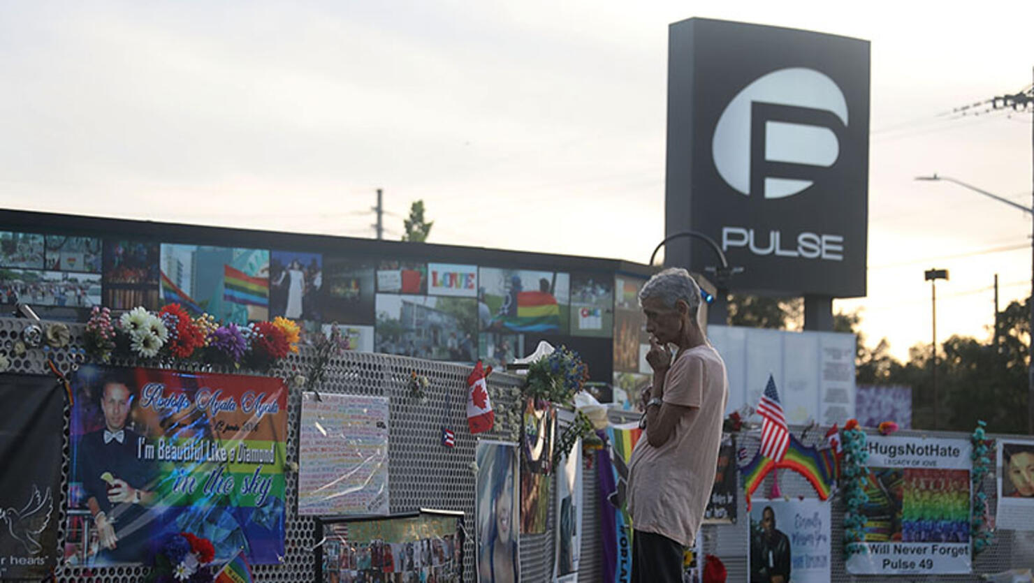 A visitor takes in the scene at the memorial to the 49 shooting victims setup at the Pulse nightclub where the shootings took place two years ago on June 12, 2018 in Orlando, Florida