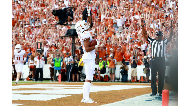 Collin Johnson celebrates in the end zone after scoring a touchdown against the Oklahoma Sooners