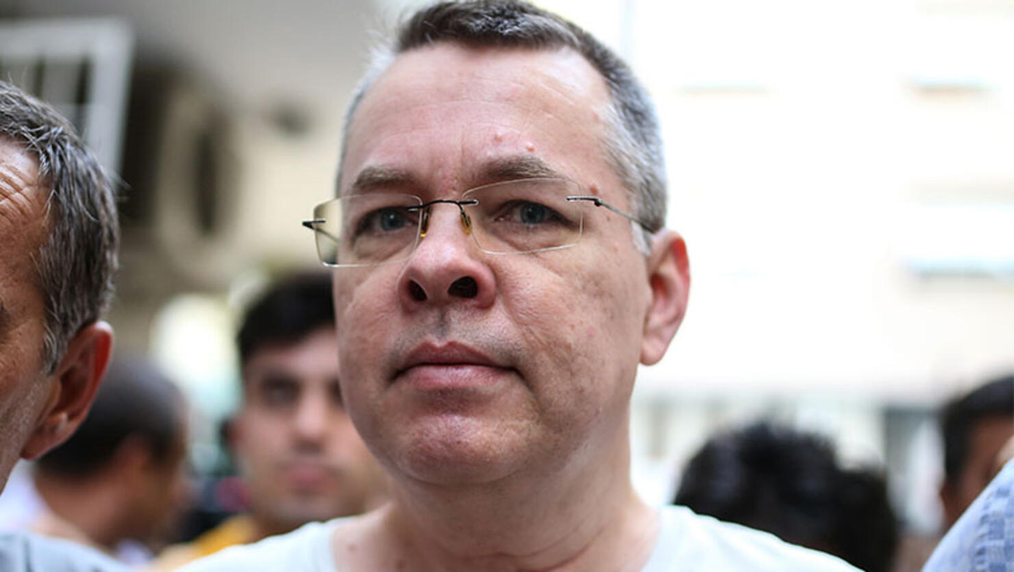 US pastor Andrew Craig Brunson escorted by Turkish plain clothes police officers arrives at his house