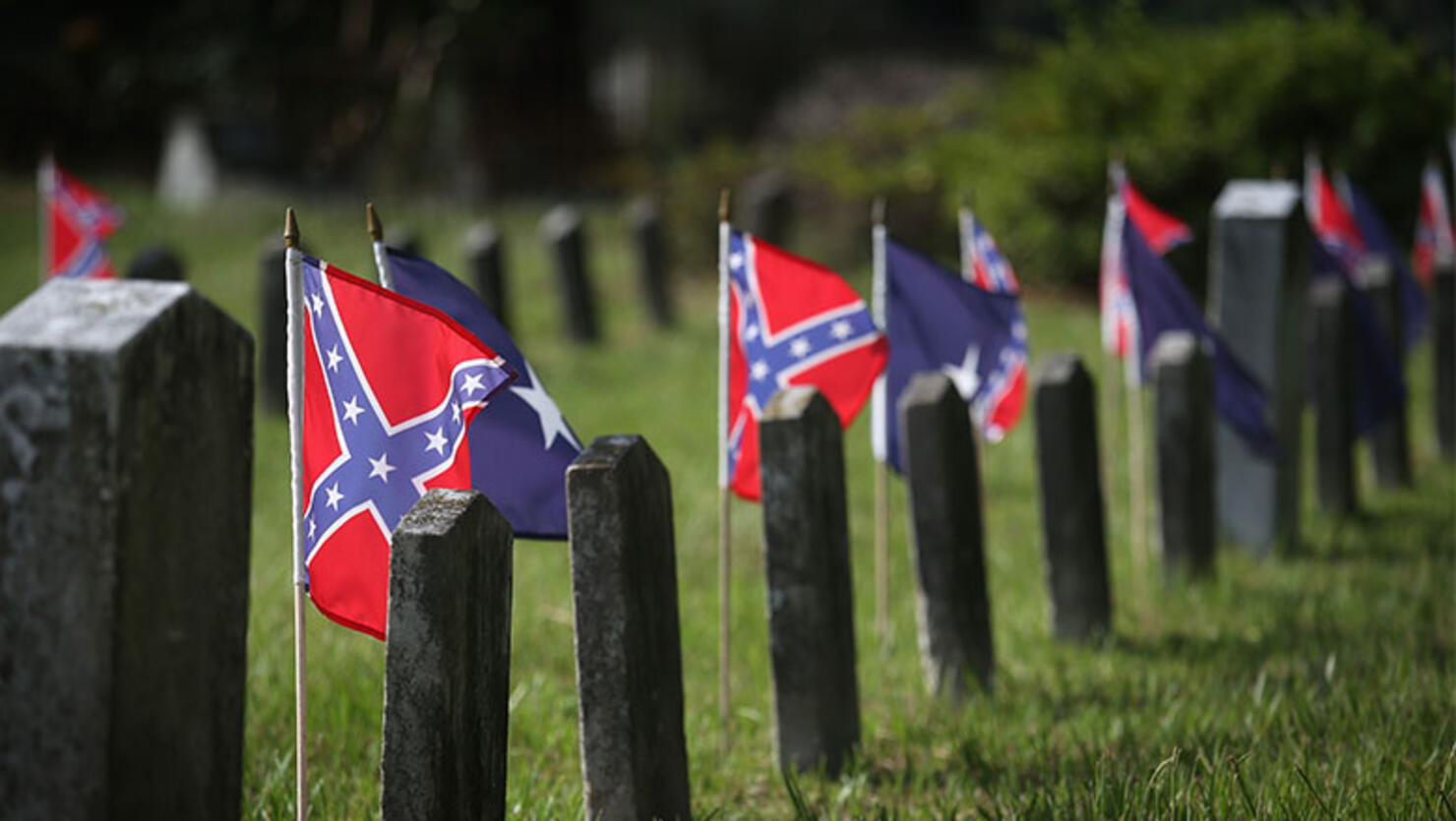 Confederate flags fly over the graves of Confederate soldiers buried in Magnolia Cemetery