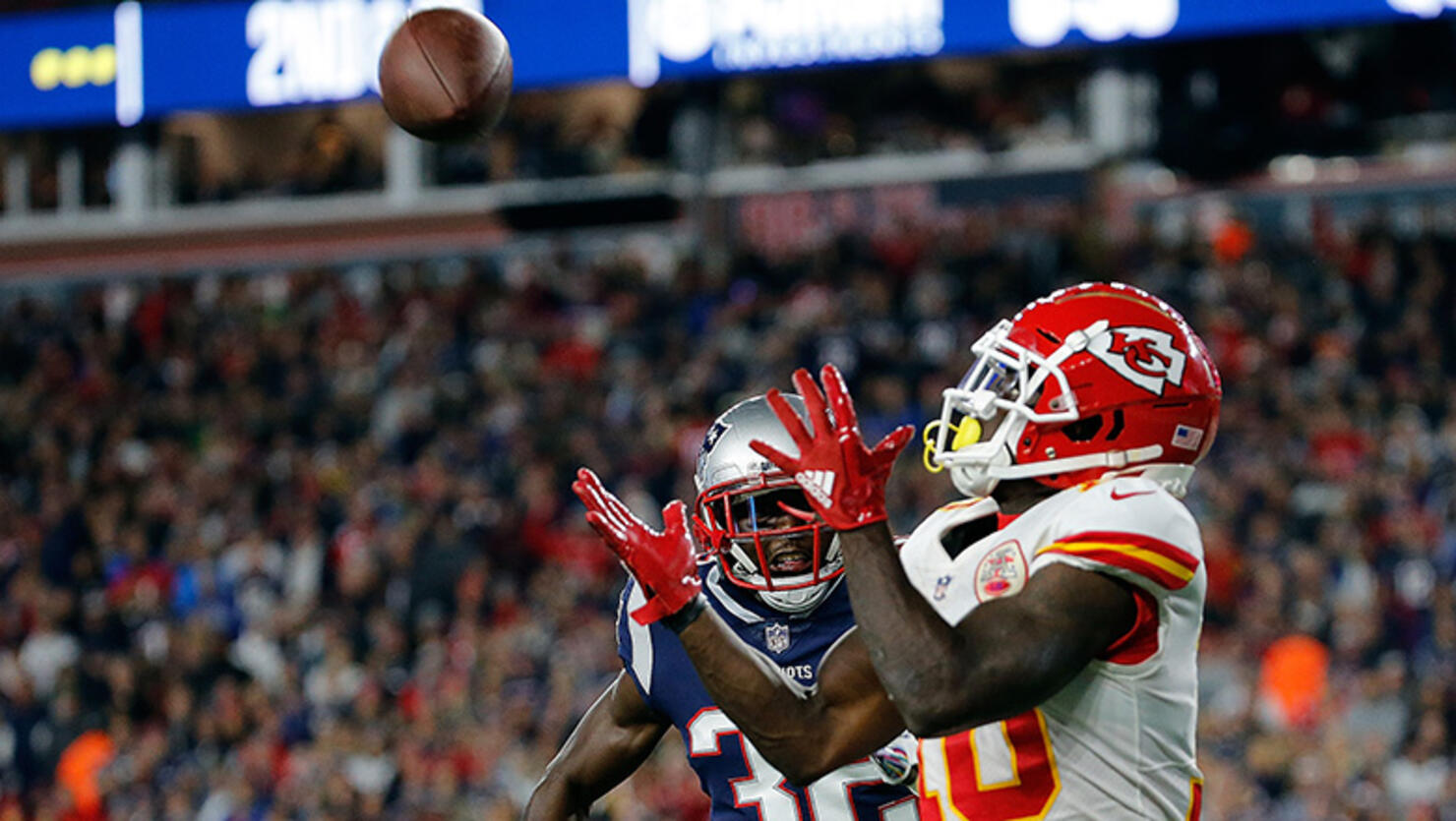 Tyreek Hill #10 of the Kansas City Chiefs catches a touchdown pass against the defense of Devin McCourty #32 of the New England Patriots