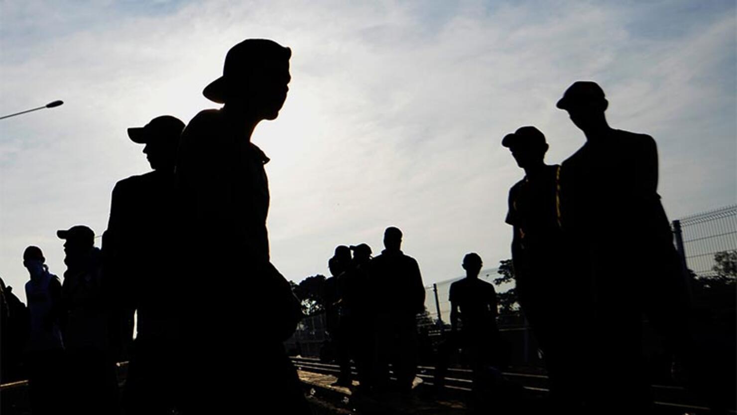 Migrants remain on the international border bridge between Guatemala and Mexico in Ciudad Tecun Uman, Guatemala, where a security fence close to the border has been reinforced a day after Honduran migrants tried to cross into Mexico