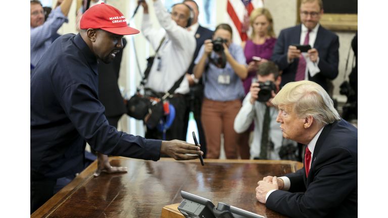 President Trump Hosts Kanye West And Former Football Player Jim Brown At The White House WASHINGTON, DC - OCTOBER 11: (AFP OUT) Rapper Kanye West , left, shows a picture of a plane on a phone to U.S. President Donald Trump during a meeting in the Oval office of the White House on October 11, 2018 in Washington, DC. (Photo by Oliver Contreras - Pool/Getty Images)