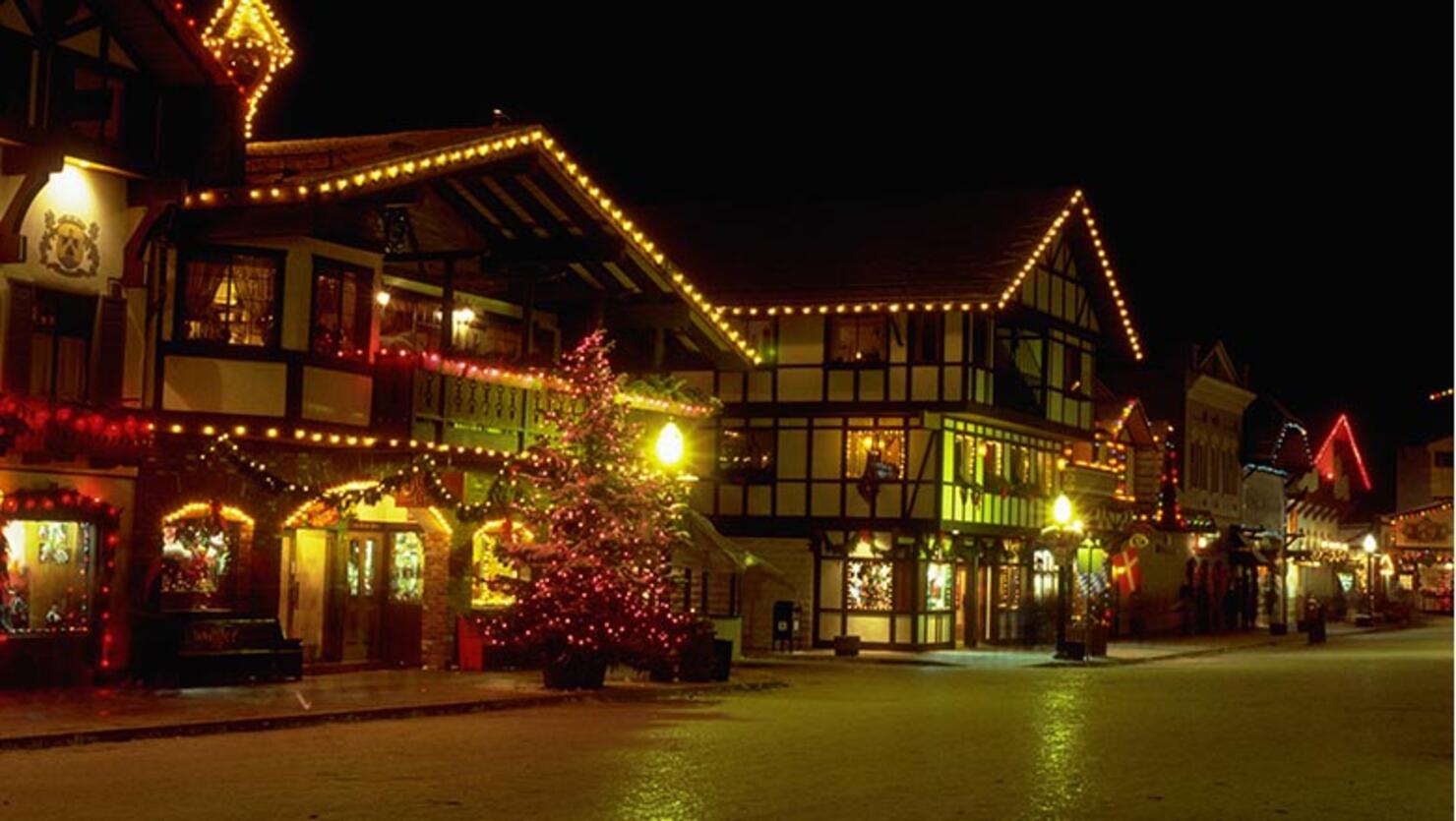 Swiss-style buildings which look like chalets, are lit up with colored lights at Christmastime in Leavenworth, Washington