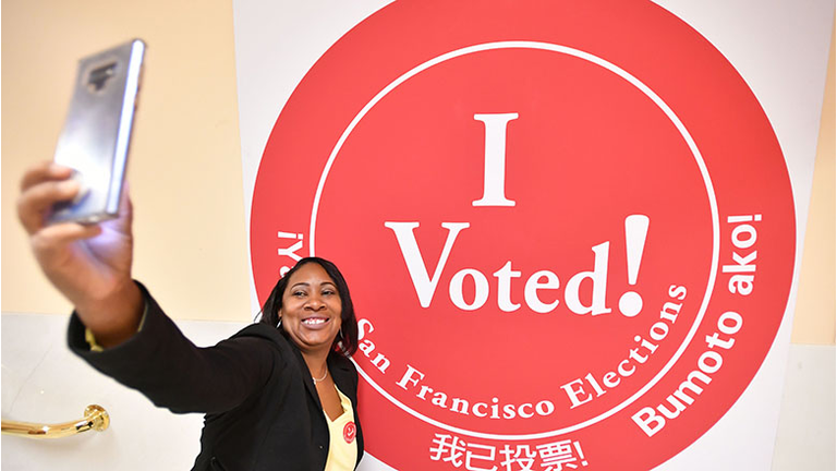 A woman takes a selfie after voting at City Hall in San Francisco, California on November 6, 2018