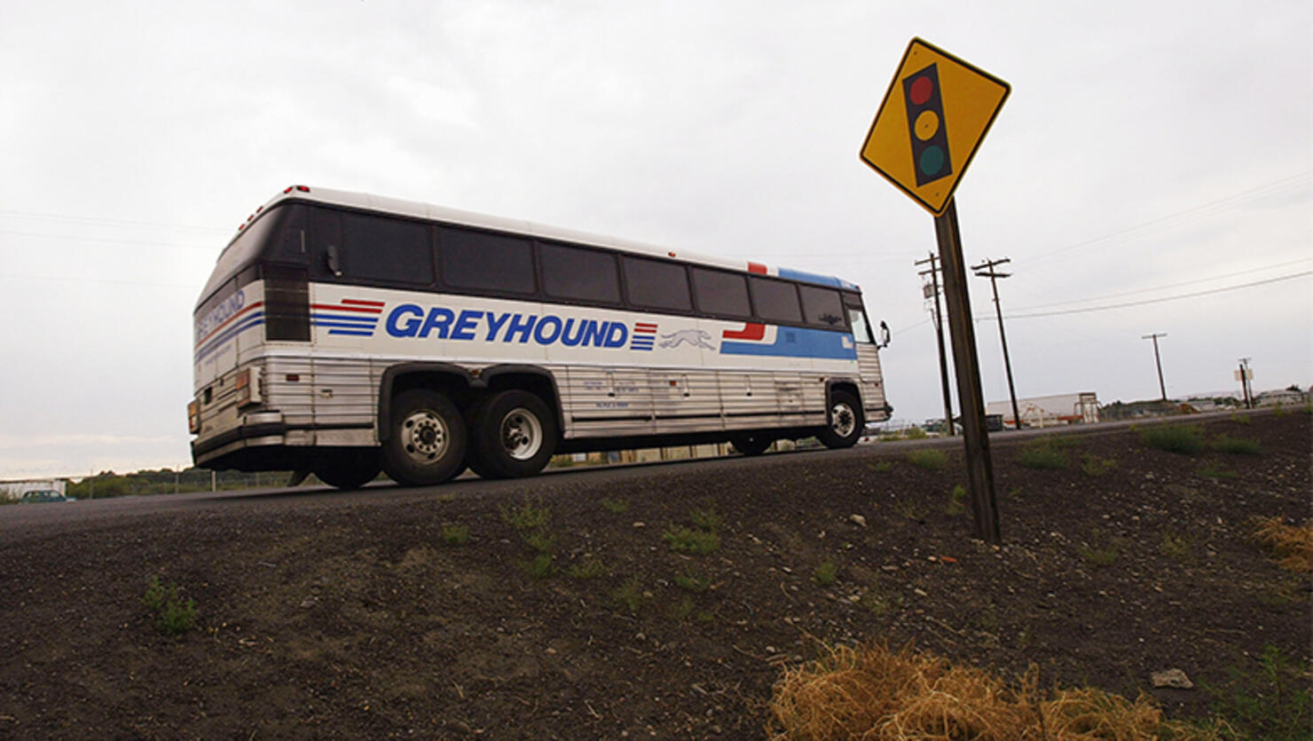 A Greyhound bus pulls out of a driveway of a diner in rural Washington state