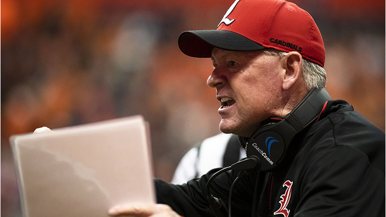 Head coach Bobby Petrino of the Louisville Cardinals disputes a call during the first quarter against the Syracuse Orange at the Carrier Dome