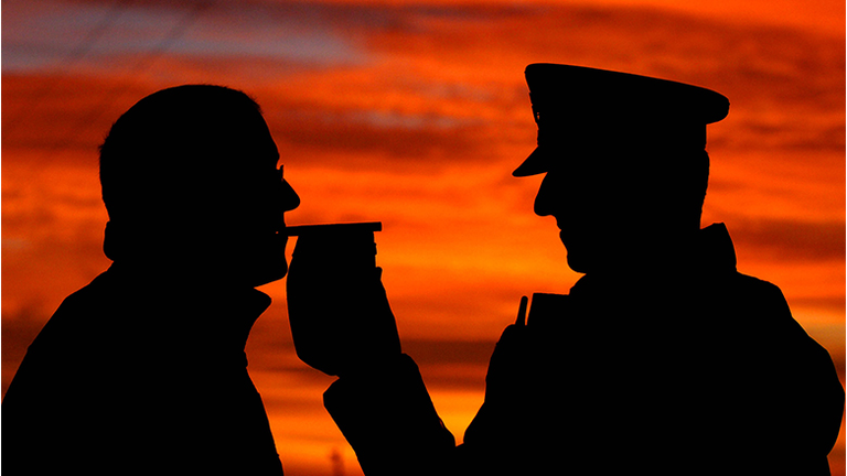 A police officer carries out a breathalyzer test.