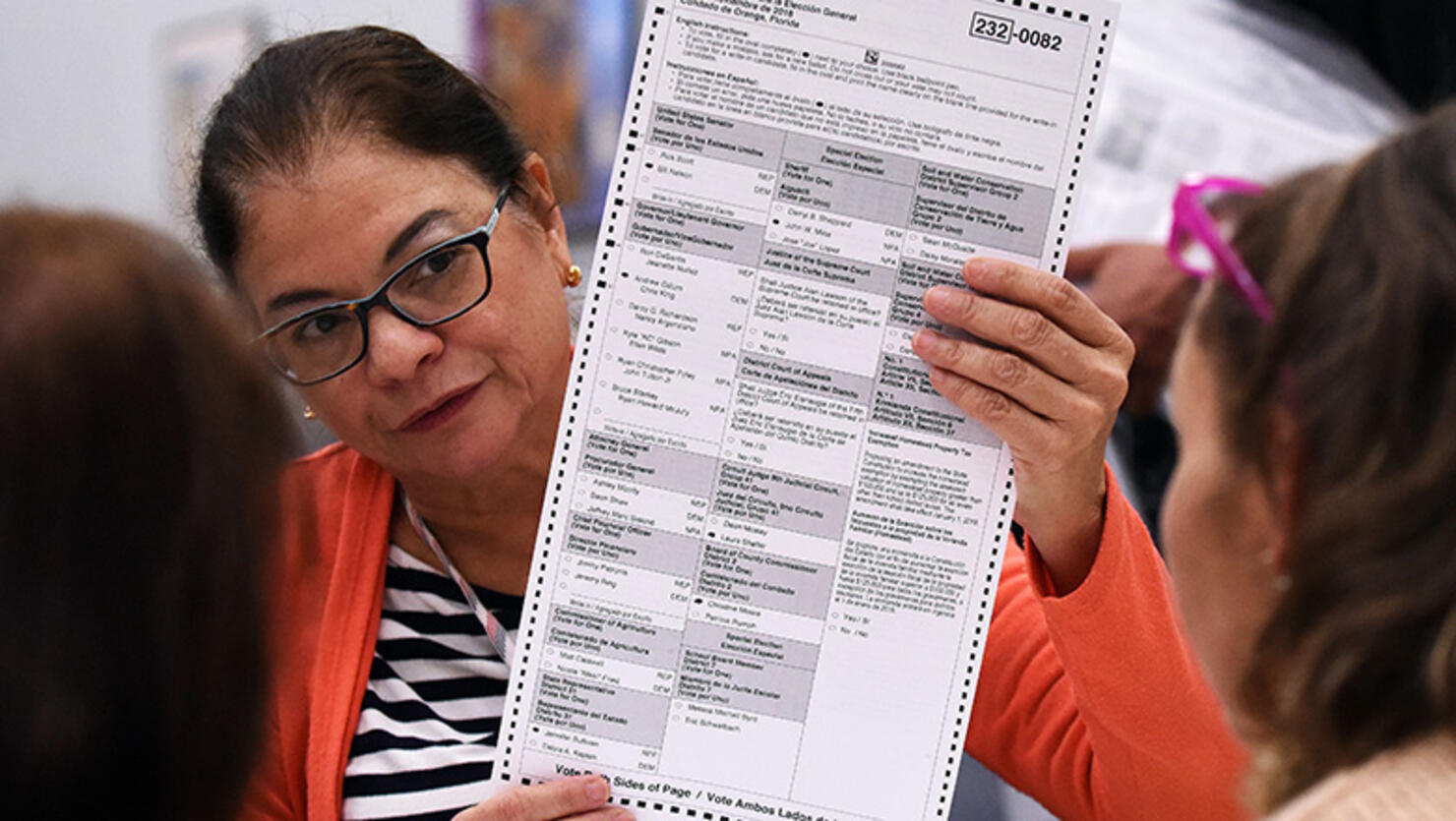 Election workers perform a manual recount of ballots on November 16, 2018 at the Orange County Supervisor of Elections Office in Orlando, Florida