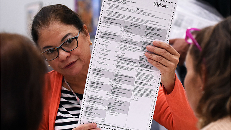 Election workers perform a manual recount of ballots on November 16, 2018 at the Orange County Supervisor of Elections Office in Orlando, Florida