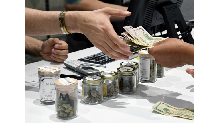 LAS VEGAS, NV - JULY 01: A customer pays for cannabis products at Essence Vegas Cannabis Dispensary after the start of recreational marijuana sales began on July 1, 2017 in Las Vegas, Nevada. Nevada joins seven other states allowing recreational marijuana use and becomes the first of four states that voted to legalize recreational sales in November's election to allow dispensaries to sell cannabis for recreational use to anyone over 21. (Photo by Ethan Miller/Getty Images)