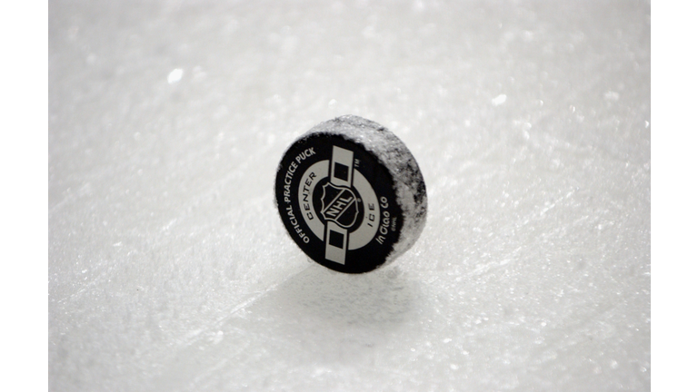 hockey pucks being given to staff at Oakland University