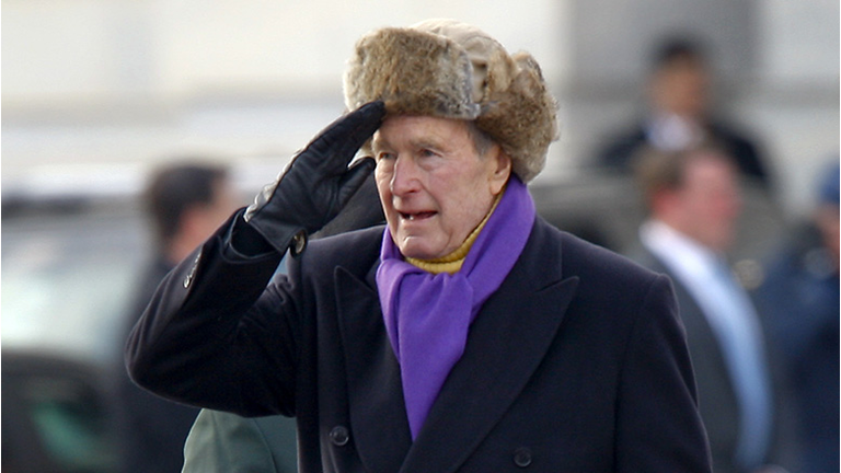 Former U.S. President George H.W. Bush salutes outside the U.S. Capitol 