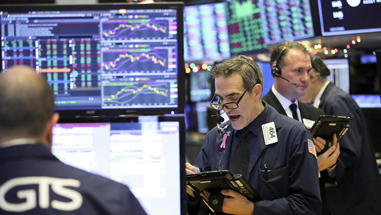 Traders work at the New York Stock Exchange in New York