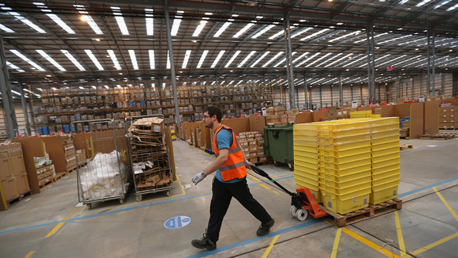 Employees select and dispatch items in the huge Amazon 'fulfilment centre' warehouse 