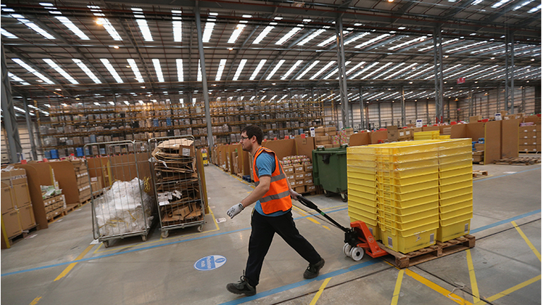 Employees select and dispatch items in the huge Amazon 'fulfilment centre' warehouse 