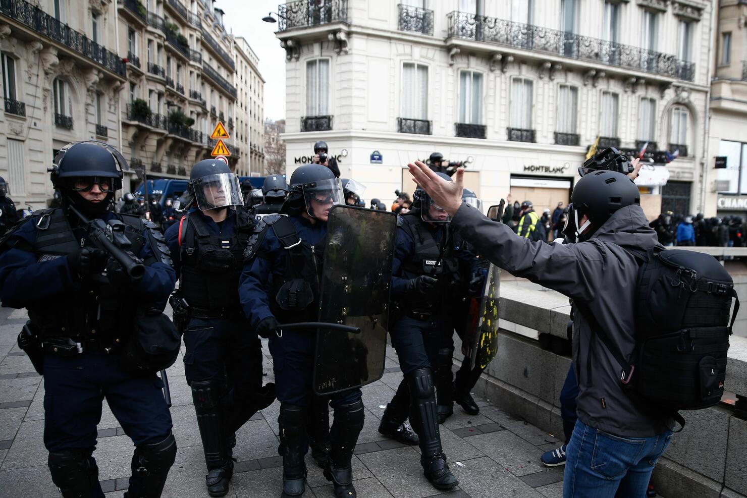 French police push back protesters with tear gas and water cannons
