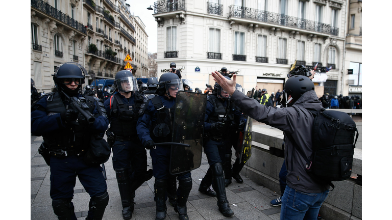 French police push back protesters with tear gas and water cannons