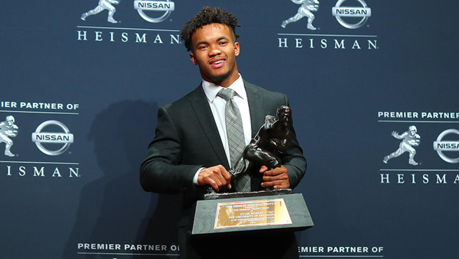 Oklahoma quarterback Kyler Murray poses for photos after winning the 84th Heisman Trophy