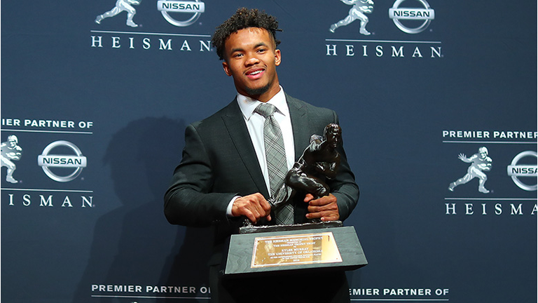 Oklahoma quarterback Kyler Murray poses for photos after winning the 84th Heisman Trophy