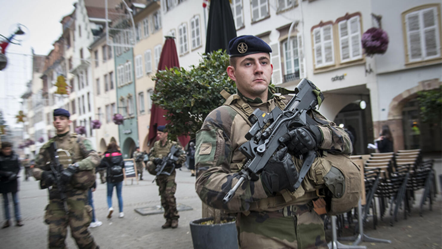 Soldiers patrol near the Christmas market where, yesterday, a man shot 14 people, killing at least three