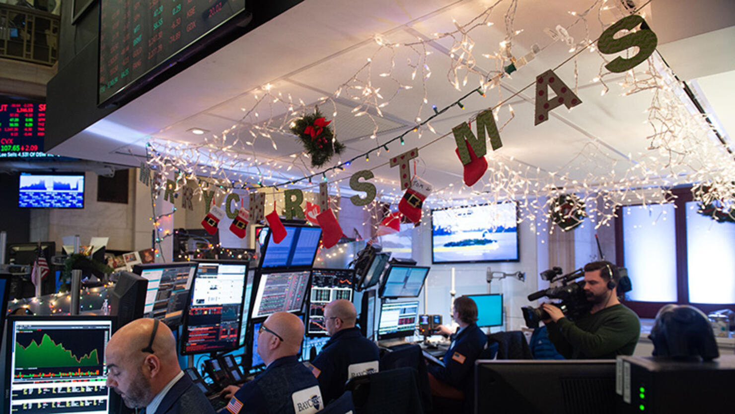 Traders work on the floor at the closing bell of the Dow Industrial Average at the New York Stock Exchange