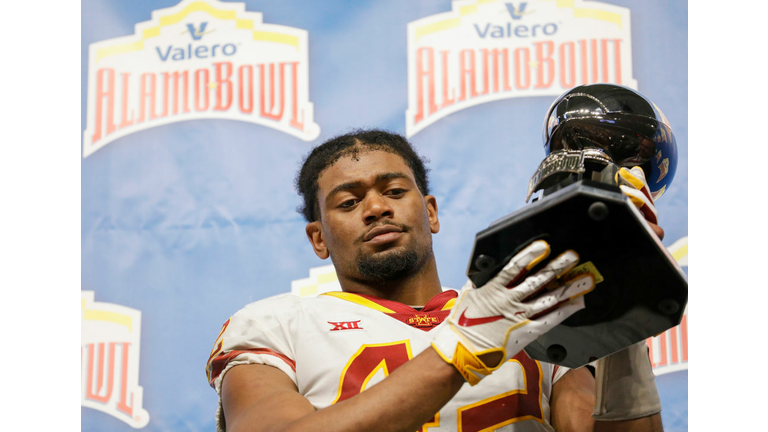 Marcel Spears Jr. #42 of the Iowa State Cyclones accepts a sportsmanship trophy 