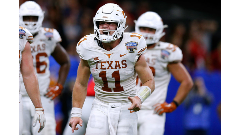 Sam Ehlinger #11 of the Texas Longhorns celebrates a touchdown 