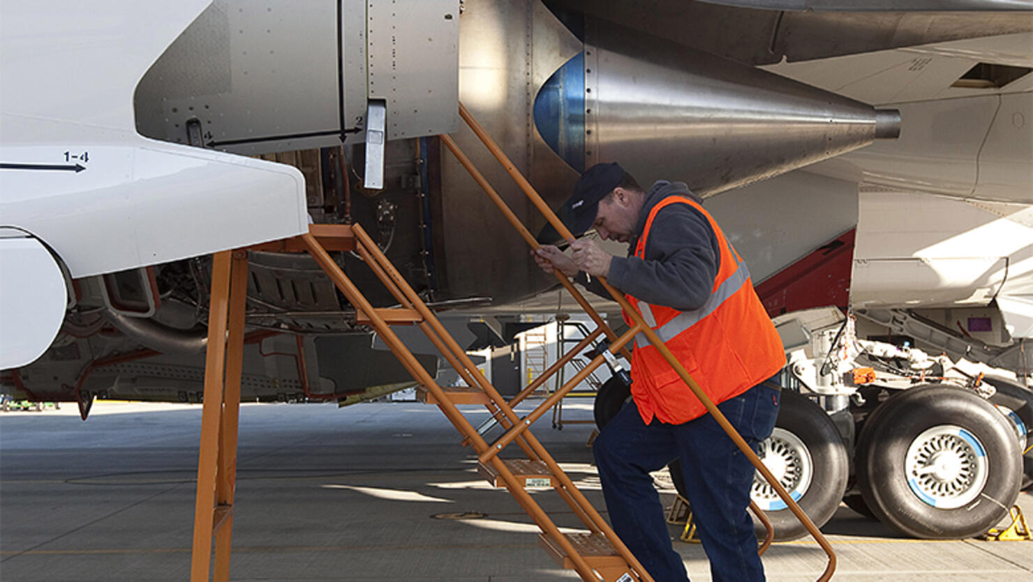 A mechanic works on an airplane