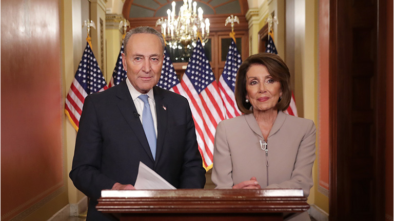 Speaker of the House Nancy Pelosi (D-CA) (R) and Senate Minority Leader Charles Schumer (D-NY) pose for photographs after delivering a televised response to President Donald Trump's national address about border security at the U.S. Capitol