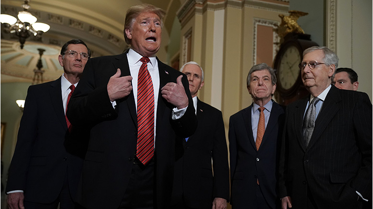 U.S. President Donald Trump (2nd L) speaks to members of the media as (L-R) Sen. John Barrasso (R-WY), Vice President Mike Pence, Sen. Roy Blunt (R-MO), and Senate Majority Leader Sen. Mitch McConnell (R-KY) listen at the U.S. Capitol after the weekly Republican Senate policy luncheon